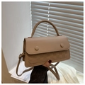 Detail view of beige crossbody bag with textured checkered pattern and metal snap buttons - Khaki