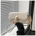 Detail of a beige PU leather baguette bag featuring a gold metal clasp and knot strap - White