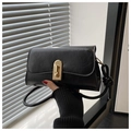 Close-up of black pleated faux leather bag with gold rectangular buckle and knot detail - Black
