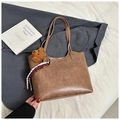 Detail of brown faux leather tote bag with teddy bear charm and striped ribbon accent - With Ornament / Khaki