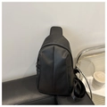 Detail view of the black matte PU leather crossbody bag with silver zippers and strap - Black