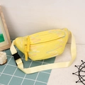 Yellow corduroy dumpling crossbody bag with wavy embroidery and tassel detail - Yellow