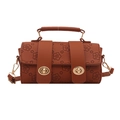 Caramel brown cylinder handbag with floral embossing and gold clasp closure on white background - Brown