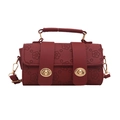 Deep red cylindrical crossbody bag featuring detailed floral embossing and golden hardware - Red
