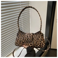 Detail of leopard print handbag showing clear texture and silver metal buckle hardware - Brown