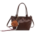 Vintage dark brown polished leather bucket bag with teddy charm and embossed lettering - Coffee With Pendant