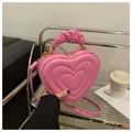 Detailed view of pink heart-shaped bag with scrunchie handle and gold zipper hardware - Pink