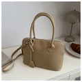 Vista dall'alto di una borsa tote in pelle kaki con eleganti cuciture bianche sul tavolo - Cachi