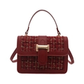 Red tweed handbag with gold thread texture and metallic clasp, front view on white background - Red