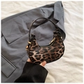 Detailed view of mini leopard print crescent handbag with gold zipper and slim handle - Brown
