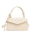 Chic cream crossbody bag with floral lace texture and elegant knotted handle design - White