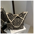 Dettaglio del set borsa a secchiello leopardata e pochette con fiocchi color crema - Bianco