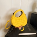 Vibrant yellow half-moon handbag with crocodile texture and circular top handle - Yellow