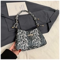 Detail of leopard print shoulder bag featuring gold hardware and a knotted strap design - Black