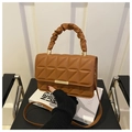 Close-up of brown quilted faux leather bag with elegant gold metal clasp and ruched handle - Brown