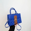 Blue quilted faux leather handbag with brown strap and gold buckle in a front view - Blue