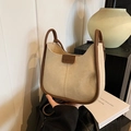 Minimalist cream shoulder bag with brown piping and fashion leather tag in a cozy setting - No Pendant / White