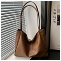 Detail of caramel brown PU leather tote bag showing soft wrinkled texture and large capacity - Brown