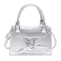 Y2K silver crossbody bag featuring a heart cutout and bow detail on a metallic surface - Silver