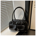 Macro shot of black glossy leather handbag with double front flap pockets and retro design - Black