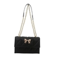 Chic black quilted chain bag with elegant gold bow hardware on a clean white background - Black