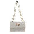 Elegant cream quilted shoulder bag featuring golden butterfly clasp and dual chain straps - White
