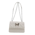 White quilted crossbody bag with silver butterfly buckle and chain strap for women - White