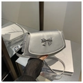 Detailed shot of silver square crossbody bag featuring a metallic bow buckle and stitch edge - Silver