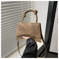 Detail of the unique knotted handle and asymmetric flap on the dark brown crossbody bag - Khaki