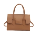 Minimalist tan crossbody bag with cylindrical handles and arrow-shaped stitching detail - Khaki