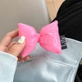 Detail of pink puffy leather bow with stylish black woven label and soft filling - Pink