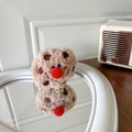 Dettaglio del supporto per telefono a forma di biscotto al cioccolato con design di mostro - Biscotto in Peluche Stile Mostro