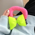 Detail of neon pink puffer wrist strap with green bow for mobile phone cases - Rose/Green