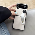 Detailed shot of white lychee leather phone case with wrist strap and cookie decor - Samsung ZFlip3 / Off White