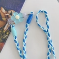 Detail of blue and white woven phone strap with translucent floral charm and metal ring - Braided Three-Strand Rope (With Back Clip) / Blue