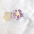 Detailed view of a purple resin flower charm with yellow core on a clear plastic base - Back Clip Only / Purple