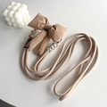 Detail of khaki fabric phone lanyard with large bow and colorful thread wrap accents - Brown Bowknot Back Clip + Colorful Woven Rope