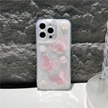 Detailed view of pink 3D butterfly and pearl flower charms on a glitter iPhone case - White Glitter with Sakura Pink Butterfly / iPhone 7/8/SE 2020