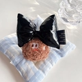 Detail of plush chocolate cookie doll with black faux leather bow and textured fabrics - Back Clip Style-Shiny Black Bow-Dark Brown Cookie / Dark Brown & Black