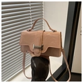 Close-up of small pink wrinkled patent leather handbag with silver buckle and handle - Pink