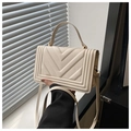 Detail of cream faux leather handbag featuring distinctive V-shaped geometric embossing - Off White