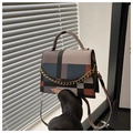 Detail view of a geometric color-block handbag with gold chain and crossbody strap - Colorful