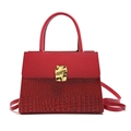 Deep red handbag featuring mock crocodile texture and a golden geometric metal clasp - Red