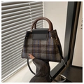 Detail of vintage plaid woolen handbag with round wooden handle and leather flap closure - Black