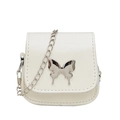 Mini white leather crossbody bag featuring a silver butterfly clasp and chain strap - White