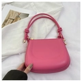Detail of pink saddle bag featuring knotted handles and premium golden hardware - Rose Red