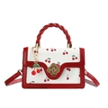 Fashionable white square handbag with red cherry prints and golden floral clasp detail - Red