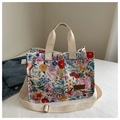 Detailed shot of floral canvas tote bag with dual front pockets and brown FASHION leather tag - Multicolor Large Floral Style (款式二)