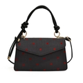 Bolso bandolera gris con lunares rojos y detalle decorativo de lazo en el asa - Lunares
