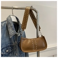 Brown vintage hobo bag with silver studs on wide strap hanging with a denim jacket - Brown